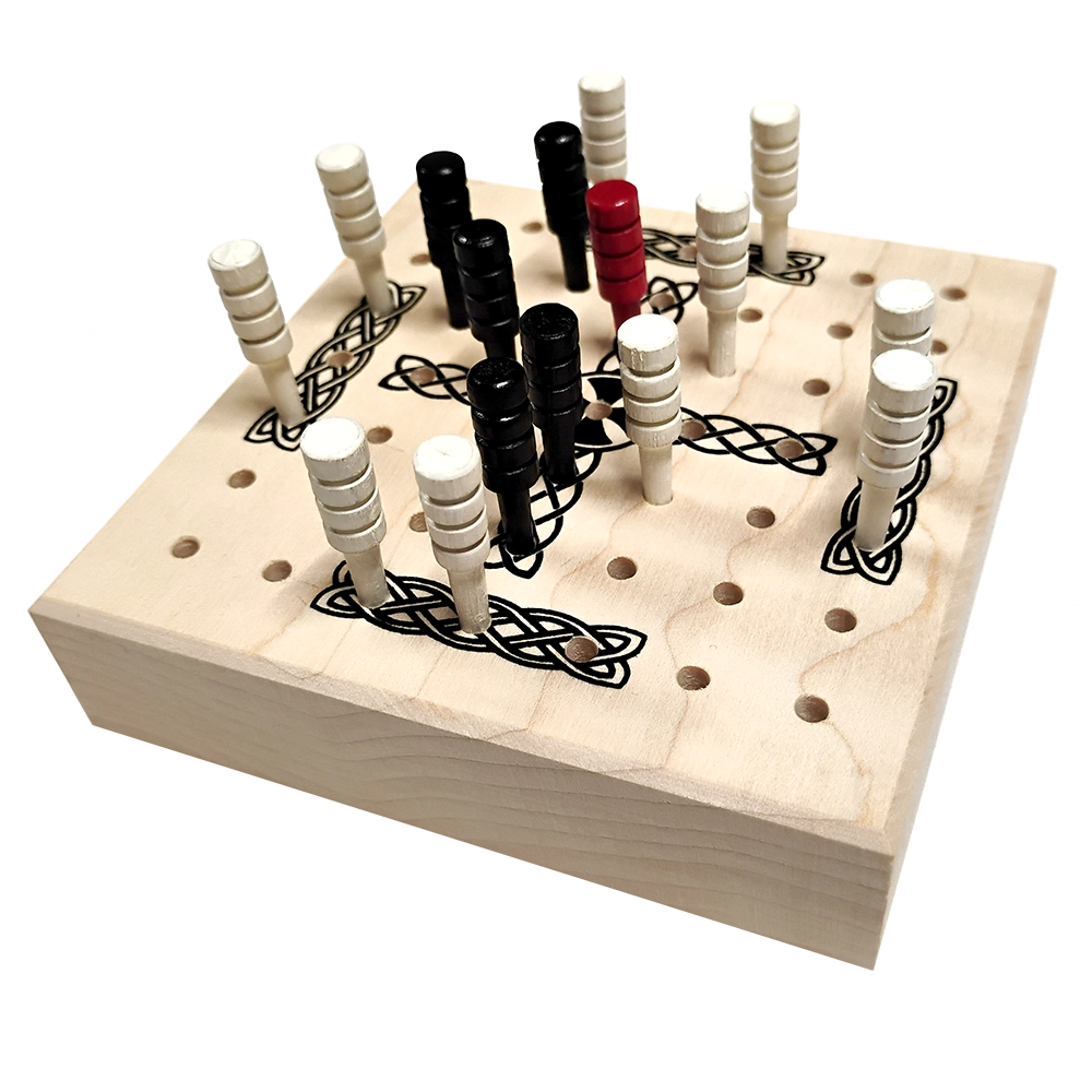 A wooden peg game board with black Celtic knot engravings, featuring white and black pegs arranged on the raised points, photographed on a clean white background.