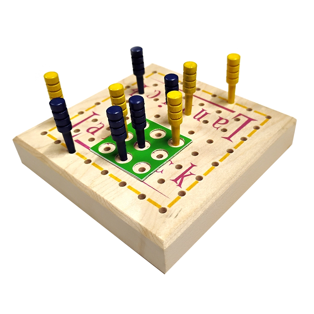 A wooden peg game board with a light natural wood base, printed red and yellow lettering and grid lines, featuring blue and yellow pegs arranged on a green playing area, isolated on a white background.