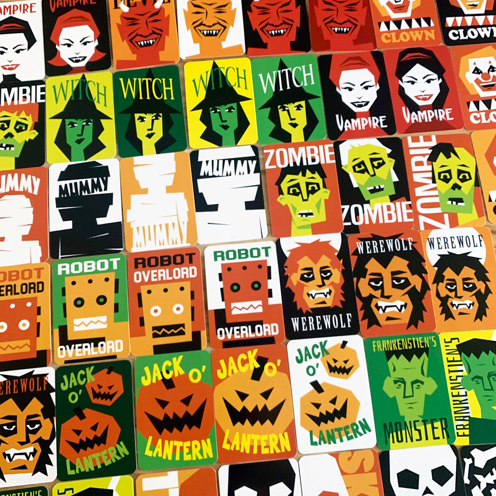 A close-up of a colorful Halloween-themed sticker or patch pattern featuring illustrated faces and labels such as witch, vampire, zombie, mummy, werewolf, jack-o'-lantern, and robot.
